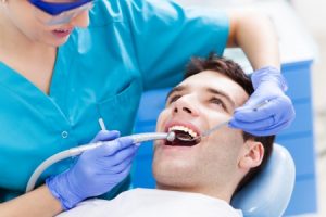  man having teeth examined by dentist